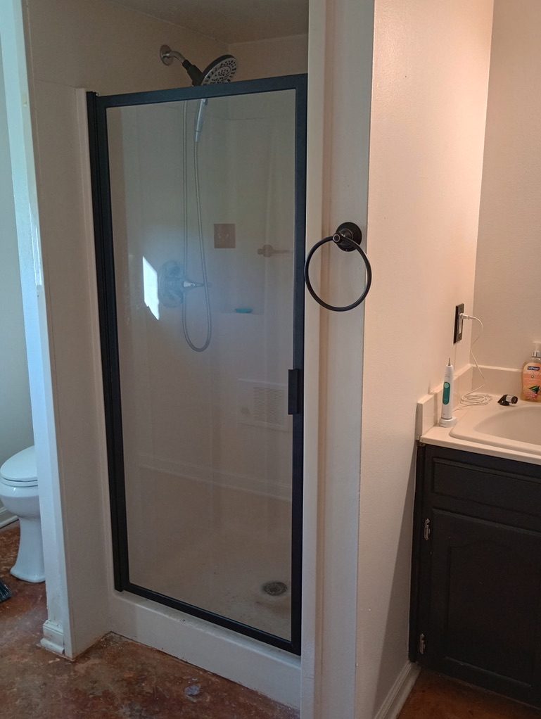 Bathroom remodel with new framed glass shower door