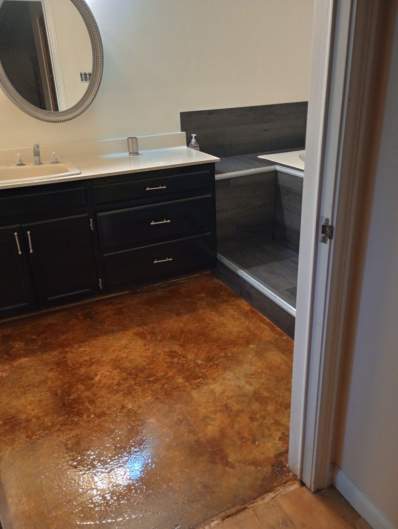 Bathroom remodel with new vanity and stained concrete floor