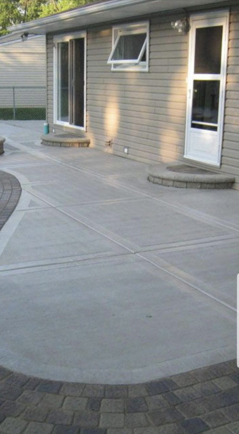 Poured concrete patio and walkway with paver border