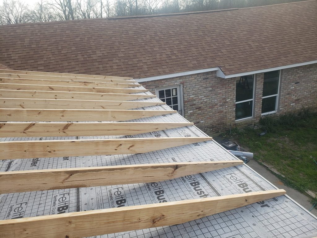 Patio roof framing set over synthetic underlayment