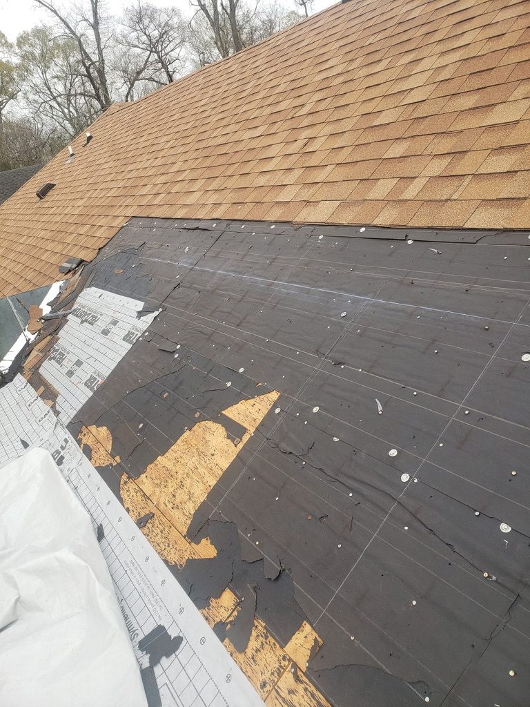 Roof tear-off exposing decking before new underlayment